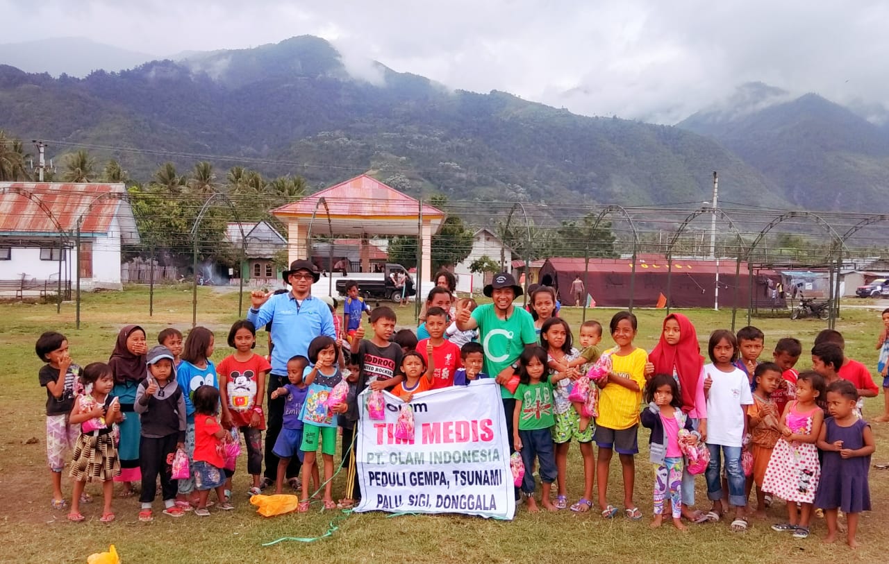 A group of children standing together outside a rural school sponsored by Olam, Indonesia. 